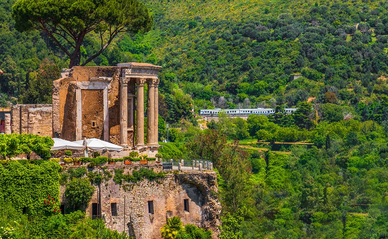 Temple of Vesta Tivoli with passing train taking day trips from Rome