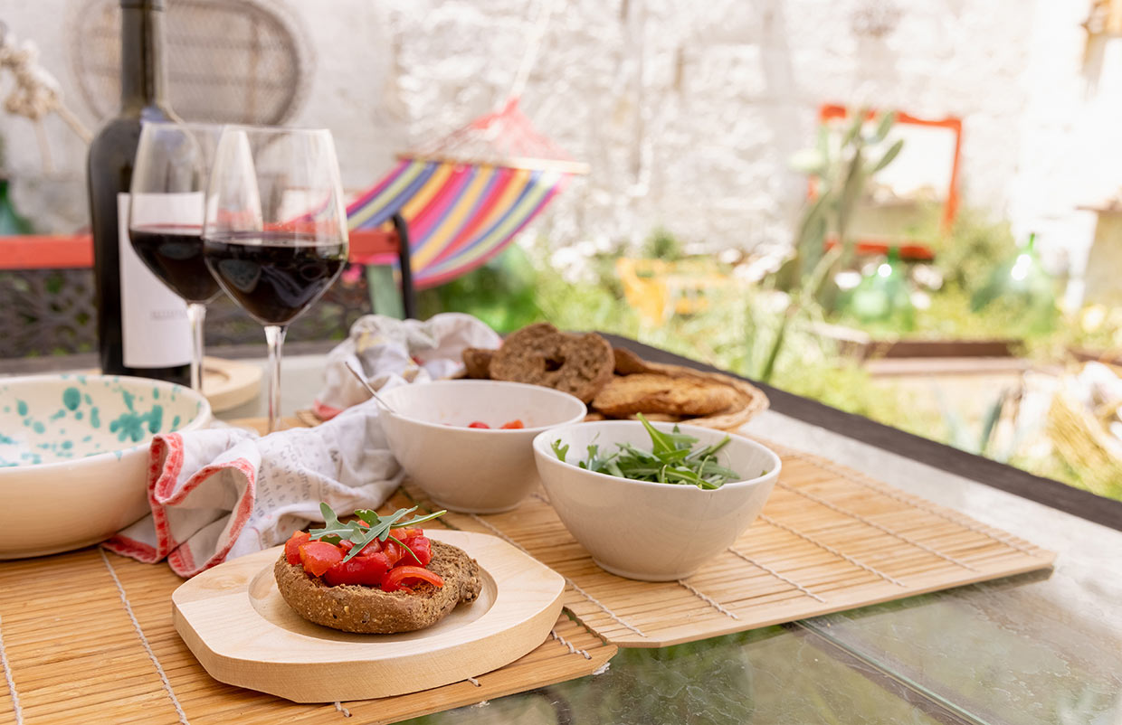 foodie reasons to visit lecce frisella and red wine served outdoors in Italy