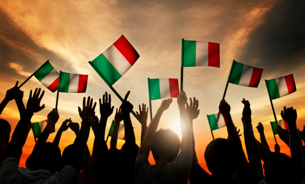 Group of people waving italian flags