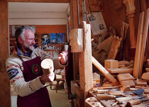 Herman Plozzer carving masks in Sauris workshop