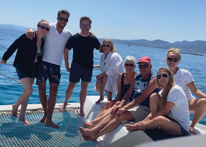 Group shot of travellers on board venturesail sailing boat on holiday in northern sardinia